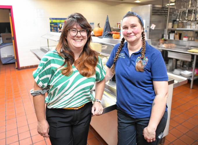 Katrina Bressani, the new food service director for the Ralph C. Mahar Regional and Union 73 school districts, with head cook Malissa Harris in the Mahar cafeteria on Monday. The other kitchen workers are Nicole Goncalves, Dawn Willard, Krista Coy, Steve Bonk and Sandy Loonie.