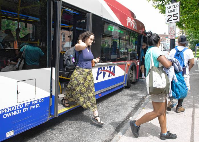 Riders get off a PVTA bus at the Pulaski Park stop on Main Street in Northampton.