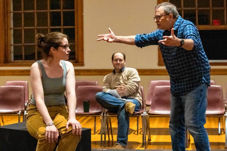 Director Matteo Pangallo, center, looks on as Lindsey Campbell and Jim Merlin rehearse Valley Players’ production of “Constellations” at Munson Memorial Library in Amherst.