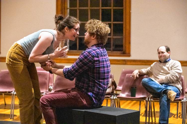 Director Matteo Pangallo looks on as Lindsey Campbell and Terrance J. Peters rehearse Valley Players’ production of “Constellations” at Munson Memorial Library in Amherst.