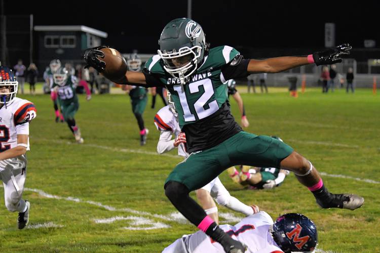 Greenfield’s Krish Patel leaps over Mahar’s Morgan Softic earlier this season.