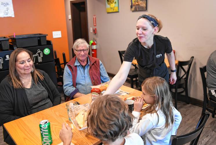 Jessica Balk delivers food to diners at Leo’s Table in South Deerfield.