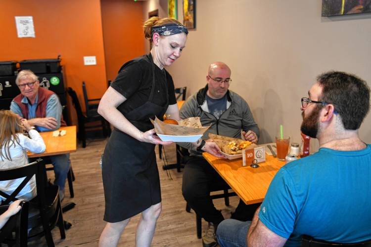 Jessica Balk delivers food to diners at Leo’s Table in South Deerfield.