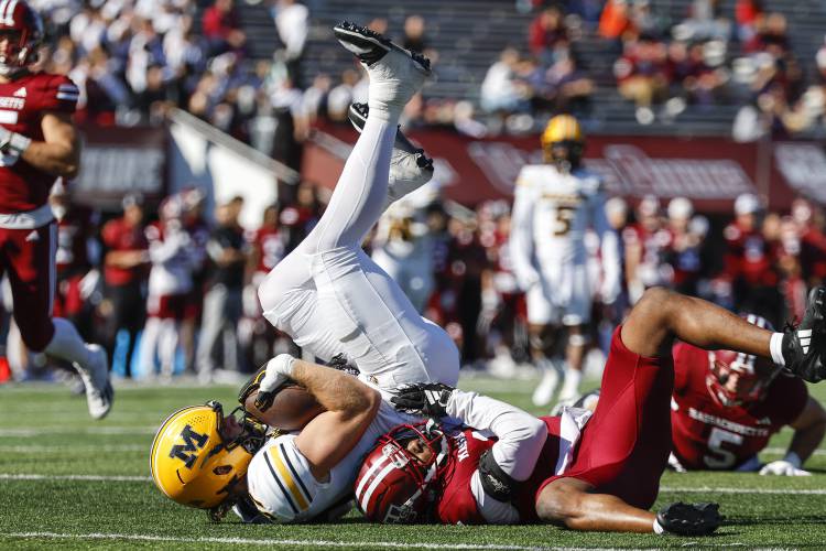 Missouri tight end Brett Norfleet makes a catch and is tackled by Massachusetts linebacker Christian LeBrun in the second half last Saturday in Amherst.