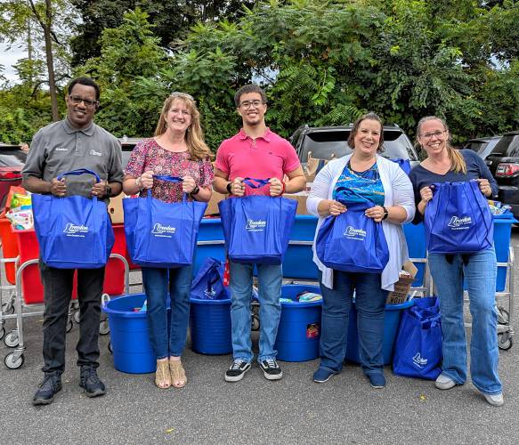 From left, Stephen Phillips, Kara Herman, Nathaniel Claudio and Natasha Cassidy from Freedom Credit Union, and Kristen McClintock, executive director of The Gray House. Food donations collected at Freedom Credit Union branches were recently delivered to the Gray House, a member organization benefiting from the Food Bank of Western Massachusetts.