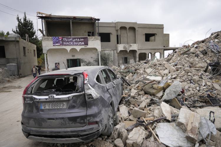 A car sits on the rubble of a building damaged in an Israeli airstrike, in Maisara near the northern coastal town of Byblos, Lebanon, Monday, Oct. 14, 2024.