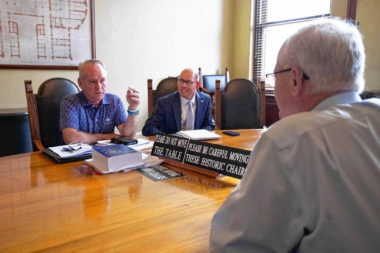 Rep. Jeffrey Roy (left) and Rep. Richard Haggerty face fellow conferee Sen. Michael Barrett across the table at the opening meeting of the clean energy conference committee on Tuesday, July 23, 2024.