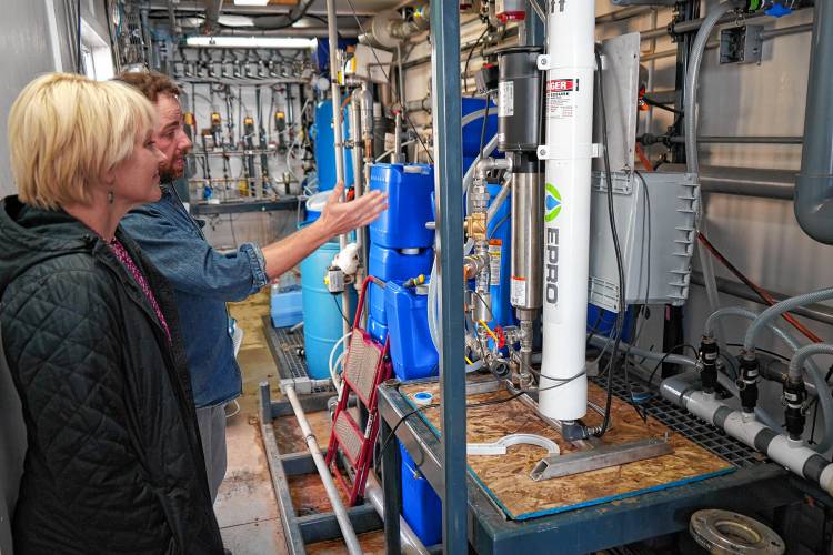 Emily Reichert, CEO of the Massachusetts Clean Energy Center, gets a tour by research engineer Patrick Wittbold of laboratory work taking place at the Water and Energy Technology Center at the University of Massachusetts Amherst on Thursday.