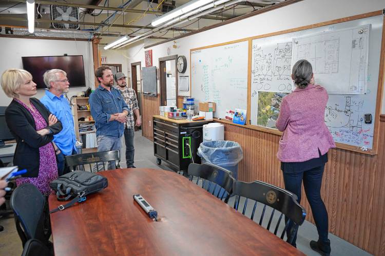 Caitlyn Butler, associate dean of research and graduate affairs for the College of Engineering, presents plans for an expanded Water and Energy Technology Center at the University of Massachusetts Amherst to Emily Reichert, CEO of the Massachusetts Clean Energy Center; David Reckhow, professor of civil and environmental engineering; and research engineers Patrick Wittbold and Christopher Watt, on Thursday.