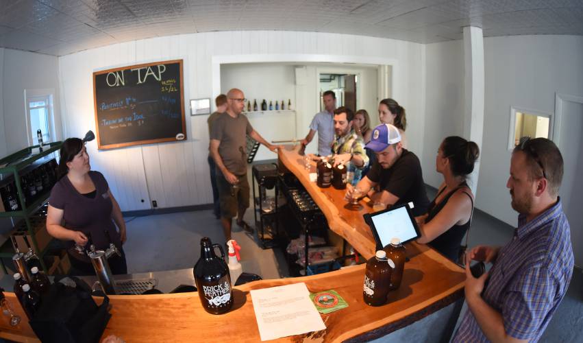 Brick & Feather Brewery on 11th Street in Turners Falls serves beer in the tasting room in 2016. After nine years in business, owner Lawrence George has announced the brewery will be closing by the end of the year.