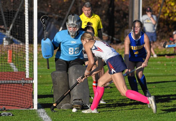 Frontier’s Ashlie Galenski (5) tries to sneak a shot past Mohawk Trail goalie Izzy Finn during the Redhawks’ 8-0 win in the Western Mass. Class C semifinals on Thursday in South Deerfield.