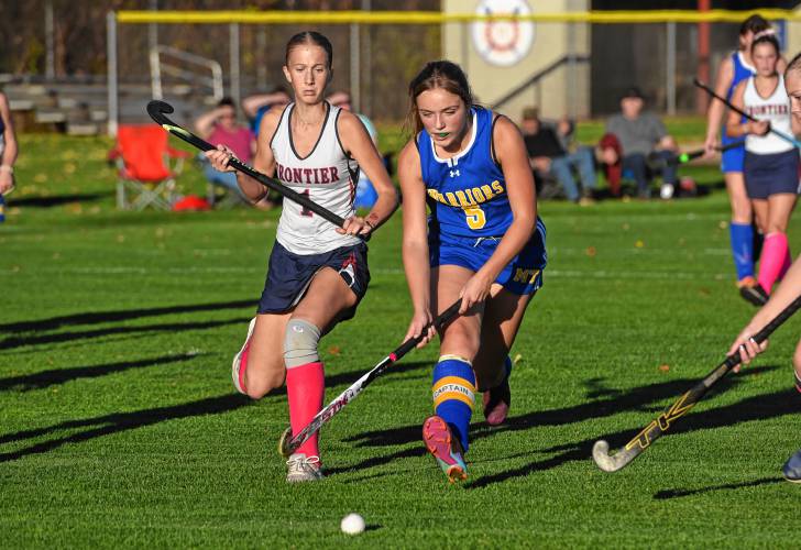 Mohawk Trail’s Avery Johnston (5) carries the ball with pressure from Frontier’s Macy DeMaio (1) during the Redhawks’ 8-0 win in the Western Mass. Class C semifinals on Thursday in South Deerfield.