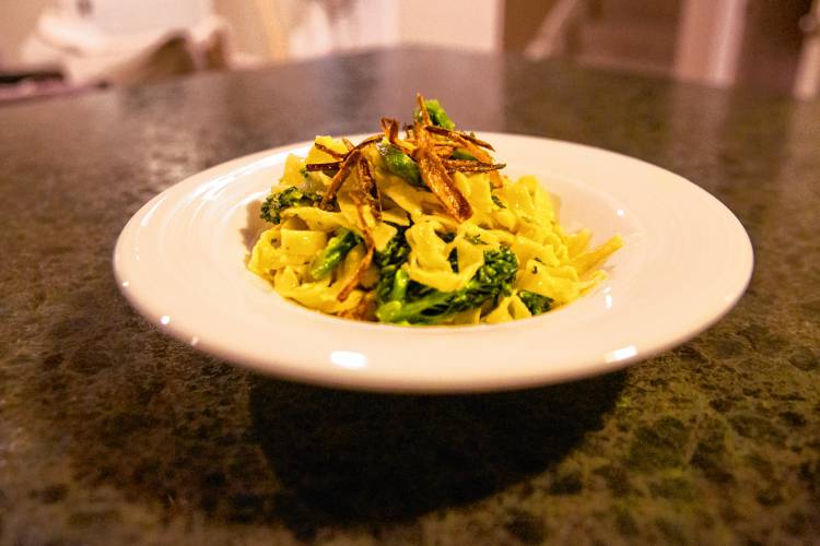 Handmade fresh stringozzi pasta with chard broccolini, Fresno chili pepper, fried shallots, and Parmesan “canna-butter.”