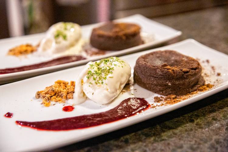 A “chocolate-canna lava cake,” inspired by a Joël Robuchon recipe, with wild berry sauce, candied walnuts, a “canna-cookie,” vanilla gelato, and mint dust.