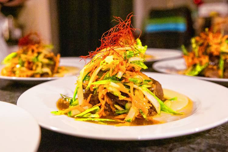 Vindaloo braised beef short rib, served with cucumber, carrot, and snap pea slaw, celeriac puree, and chili threads.