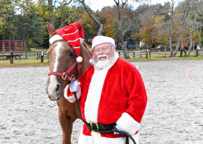 Santa, also know as Jeffrey Gordon, with Logan the horse, will be donating money he raises through professional Santa services to the Courageous Strides therapeutic riding program in Bernardston.