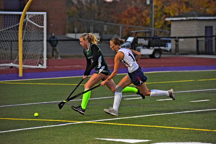 Greenfield’s Gloria McDonald (5), left, carries the ball under pressure from Frontier’s Macy DeMaio (1) during the Redhawks’ 2-0 victory in the Western Mass. Class C final on Monday night in Holyoke.