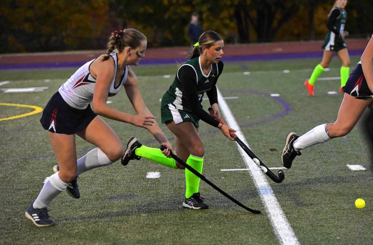 Greenfield’s Grace Laurie, right, carries the ball while defended by Frontier’s Elsa Brown during the Redhawks’ 2-0 victory in the Western Mass. Class C final on Monday night in Holyoke.