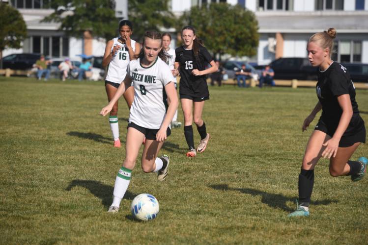 Greenfield's Holly Babineau dribbles the ball while defended by Pioneer's Maddie Keefe earlier this season in Northfield. 