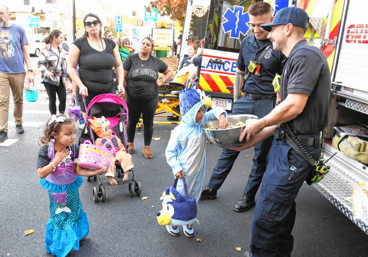 Fire and EMS giving out candy on the Greenfield Common during trick-or-treating in Greenfield.