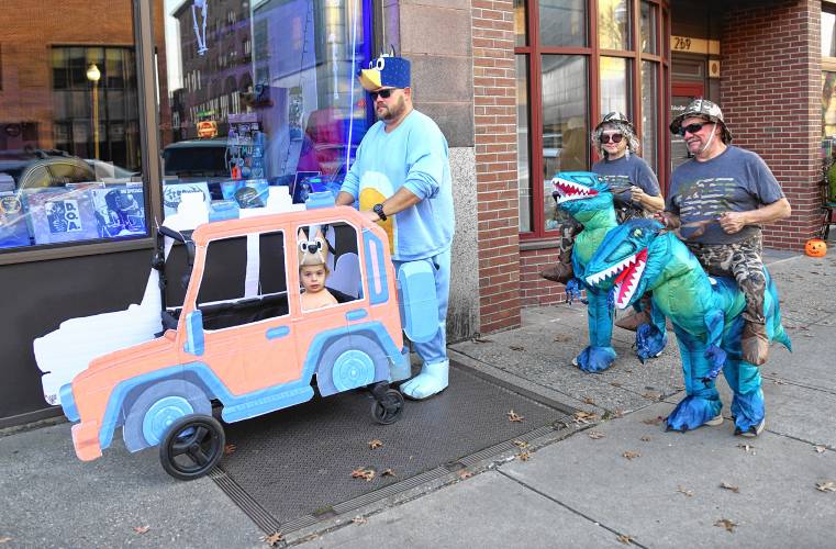 Adults dressing up and having fun trick-or-treating in Greenfield.