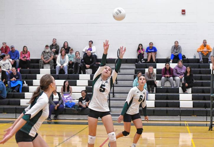 Greenfield’s Amy Mihailicenco sets the ball for Julia Bellville, left, as Mackensie Goncalves looks on against Franklin Tech at Nichols Gymnasium earlier this season. 