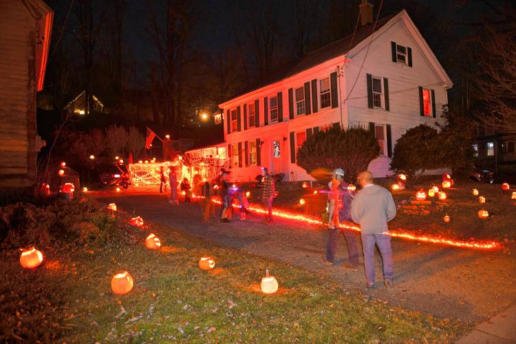 This house on River Street (Rt. 116) in Conway is adorned with dozens of carved and lit pumpkins on Halloween night as trick-or-treaters go house to house.