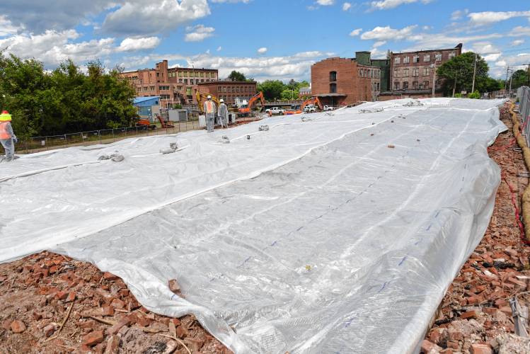 Tarps cover the debris from the June 2022 cereal factory fire in Orange.