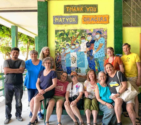 Mosaic artist Cindy Fisher and a group travelers with a mosaic they created in Guatemala in April