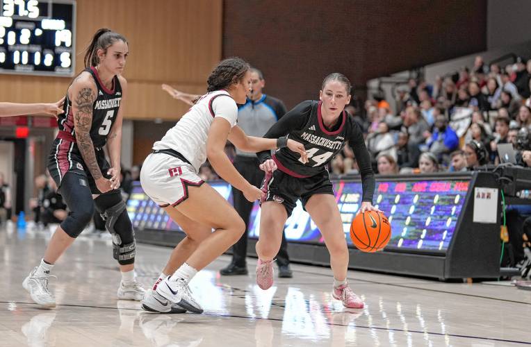 UMass’ Stefanie Kulesza (44) drives against Harvard during the Minutewomen’s season opener on Monday night in Cambridge.