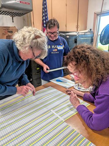 Hawley’s tally sheets for counting votes by hand. Pictured are Melanie Poudrier and Lorraine McCarthy, warden and poll worker.