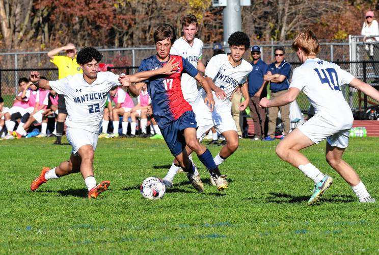 Frontier’s Eric Larsson tries to dribble through Nantucket defenders Alexis Pena (22) and Diego Roman (40) during an MIAA Div. 4 Round of 32 contest in South Deerfield Tuesday.   