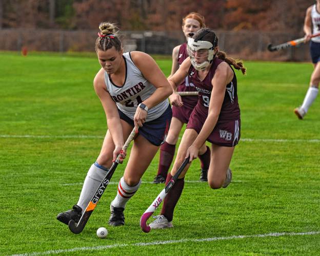 Frontier’s Claire Kirkendall (21), left, carries the ball while defended by West Bridgewater’s Noah Reynolds (9) during the Redhawks’ 5-0 win in the MIAA Division 4 Round of 16 on Wednesday in South Deerfield.