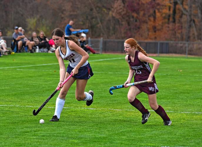 Frontier’s Addie Harrington, left, carries the ball past West Bridgewater’s Sarah Diedrichsen (13) during the Redhawks’ 5-0 win in the MIAA Division 4 Round of 16 on Wednesday in South Deerfield.