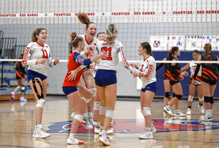 Frontier players celebrate a point against South Hadley in the third set Monday at Goodnow Gymnasium in South Deerfield.