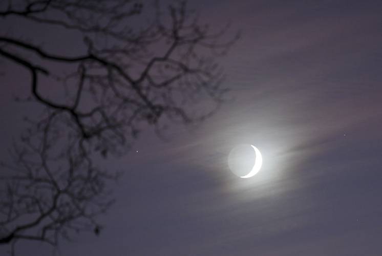 The crescent moon shines over Green River Cemetery in Greenfield on Tuesday evening.