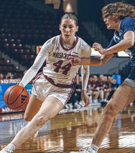 UMass guard Stefanie Kulesza drives to the hoop against New Hampshire’s Sydney Lusher (30) during the first half of the Minutewomen’s 48-45 loss to the Wildcats on Thursday night at Mullins Center in Amherst.