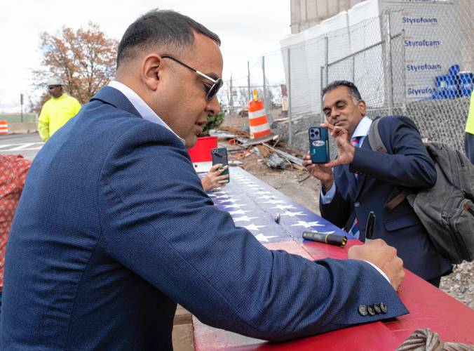 Holyoke Mayor Joshua Garcia signs the steel beam along with many others during a “topping off” ceremony at the Veterans Home in Holyoke Thursday afternoon.