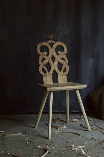 A chair with a hand carved snake made by Charles Thompson.