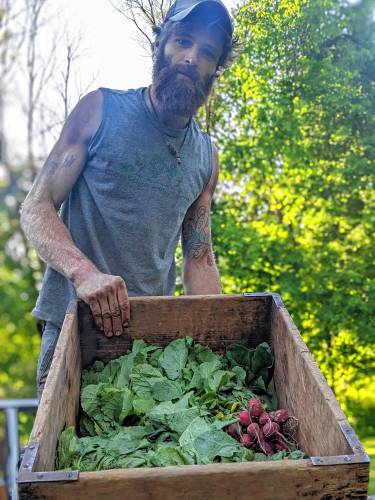 Jared Duval, owner of Coolidge Hill Farm in New Salem, with some of this summer’s harvest.