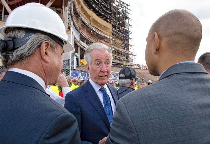 U.S. Rep. Richard Neal talks with Joseph Albanese, left, chairman and CEO of Commodore Builders, and Jon Santiago, the state secretary of Veterans Services at the Veterans Home in Holyoke on Thursday.