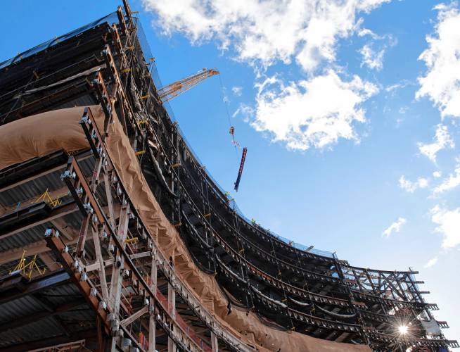 The steal beam gets lifted into place during  the topping off ceremony of the  Massachusetts Veterans Home at Holyoke  on Thursday. 