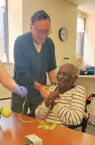 Participants at the Community Engagement Center in Greenfield share camaraderie and laughs while making apple pies.