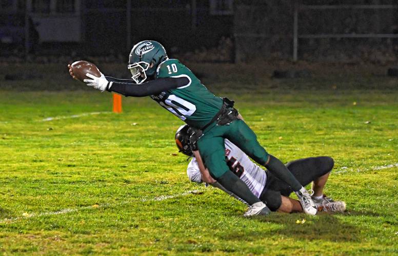 Greenfield’s Mason Cummings stretches for a touchdown in the first quarter of the Green Wave’s 46-13 win over Belchertown at Veterans Memorial Field in Greenfield Friday night. 