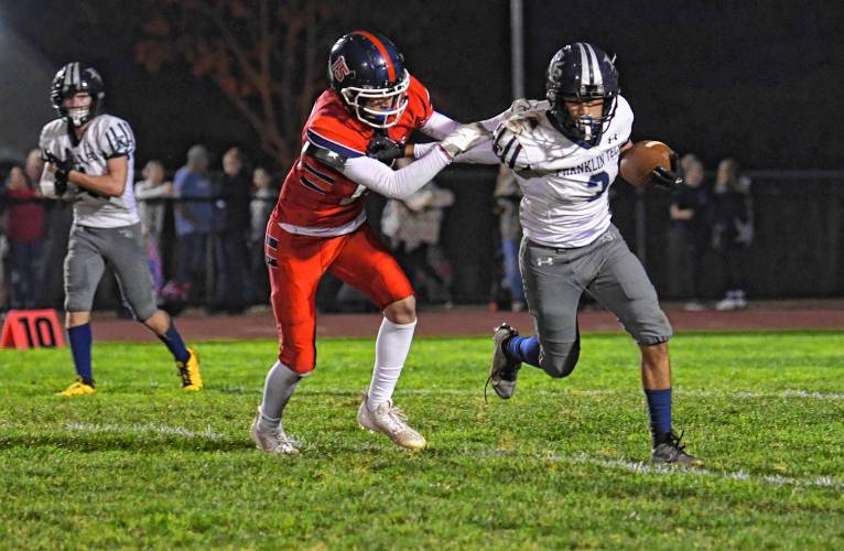 Frontier’s Carter Robinson chases down Franklin Tech’s Nolyn Stafford in South Deerfield earlier this season. 