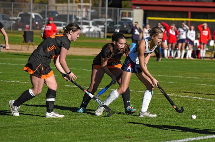 Frontier’s Ashlie Galenski (5) holds possession in front of a pair of Ipswich defenders during the Redhawks’ 2-0 win in the MIAA Division 4 quarterfinal round on Saturday in South Deerfield.