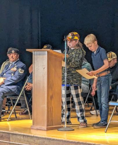 Two students speak at a Veterans Day event at Buckland-Shelburne Elementary School, which welcomed members of the Kennedy-Chamberlain Veterans of Foreign Wars Post 8503 on Friday. Though participation in veterans service organizations has waned considerably, group leaders in Franklin County say membership remains strong.