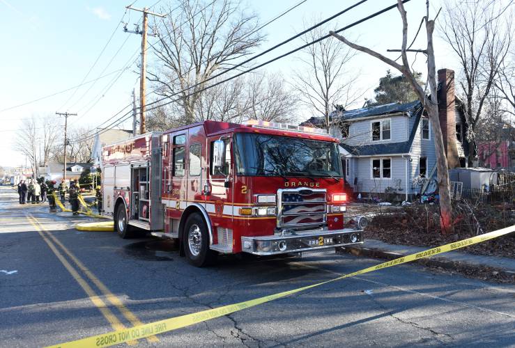 Fire crews on scene the day after a fatal house fire at 99 West River St. in Orange on Dec. 13, 2023.