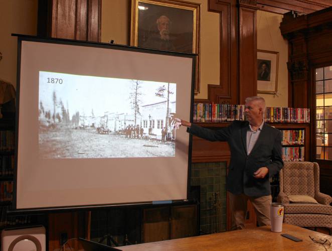 Wheeler Memorial Library welcomed Charles Marohn, founder and president of Strong Towns, a nonprofit dedicated to helping American cities and towns achieve financial resiliency, on Wednesday night. He is pictured pointing to a 1870 photo of his hometown in Minnesota.