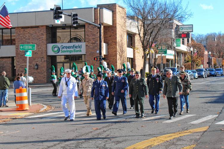 Veterans march down Main Street in Greenfield’s Veterans Day parade on Monday.